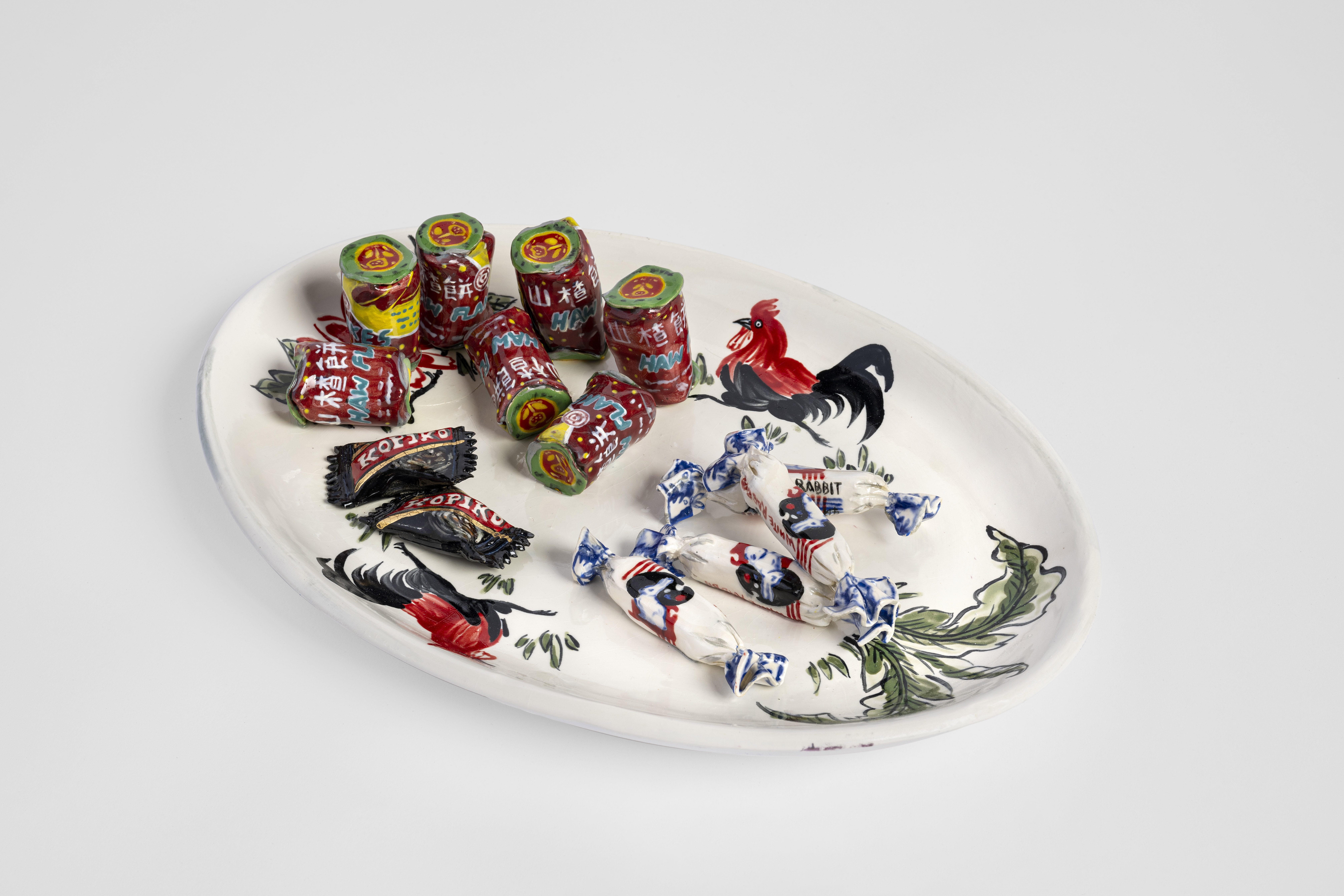MBOU54_Bounpraseuth_Rooster Plate with Haw Haw Kopiko and White Rabbit Candy_2023_glazed earthenware and gold lustre