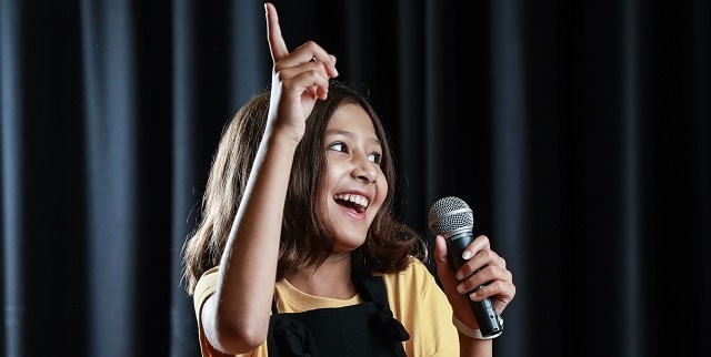 Girl with microphone on the stage
