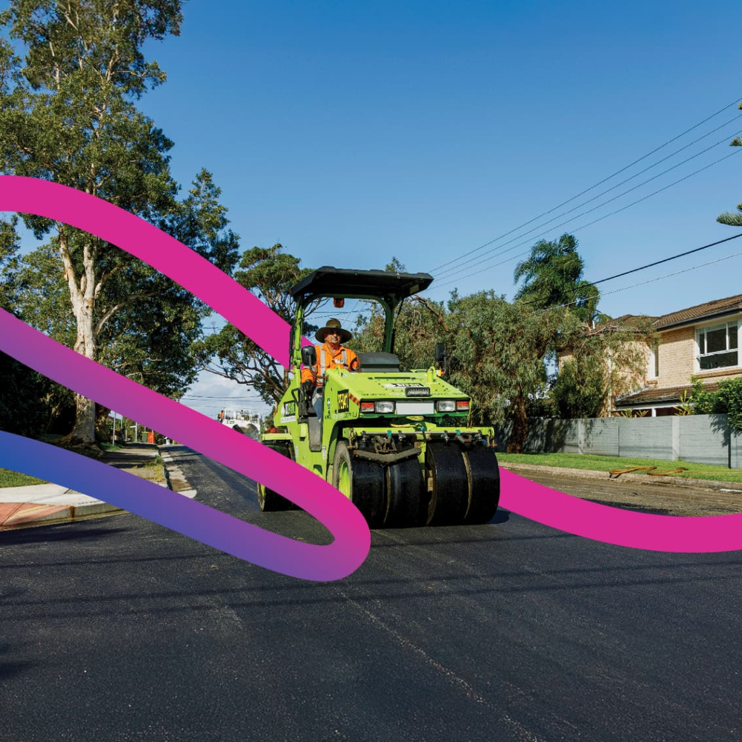 Roller flattening newly laid road sheeting - decorative ribbon digitally added to the image