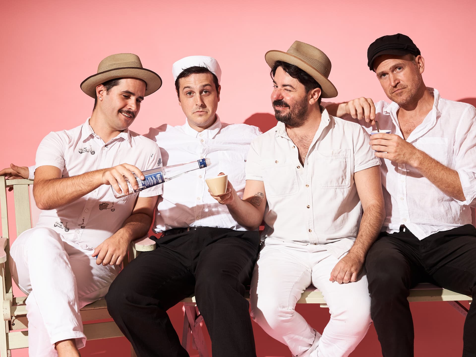 Four men in hats on a bench