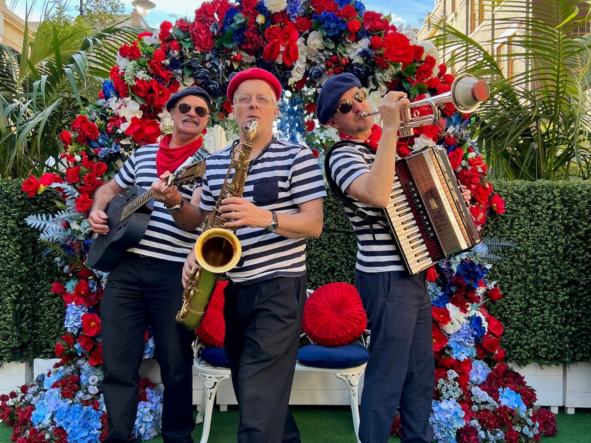 three piece jazz trio in striped shirts in berets