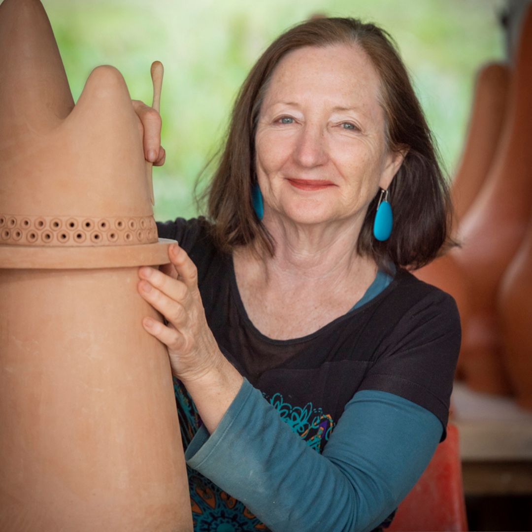 Julie Bartholomew in her sunlit studio, sculpting a large piece of clay.