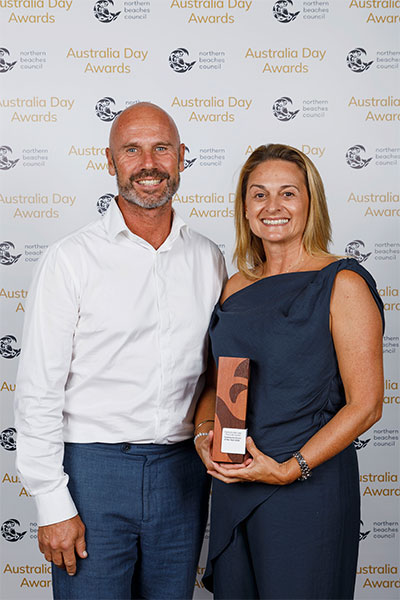 Glenn and Clare Wysman on behalf of The Link Church, recipients of the 2025 Community Event of the Year Award (Carols by the Lake Event) at Northern Beaches Council's Australia Day Awards Ceremony at Glen Street Theatre, Belrose