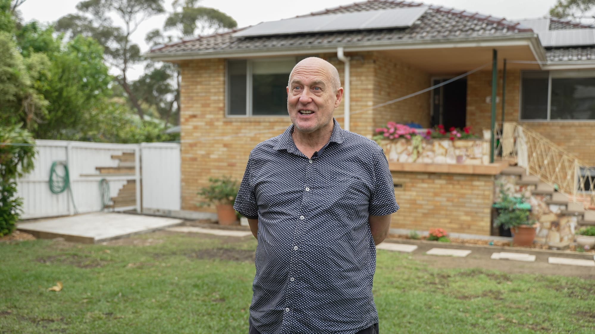 Person standing in front of their house