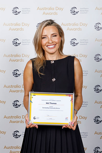 Mel Thomas holding her certificate