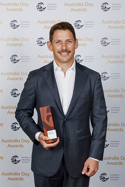 Chris Turnball holding his award