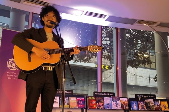 Musician playing guitar on stage