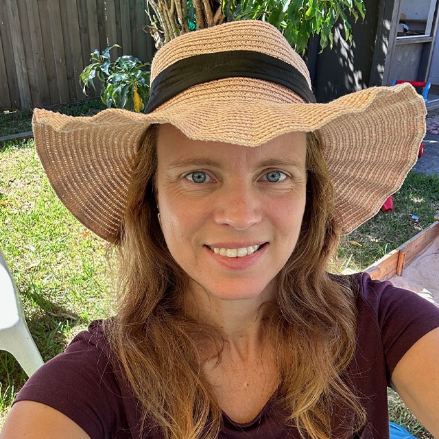 Bio photo of Julia wearing a sunhat in the garden