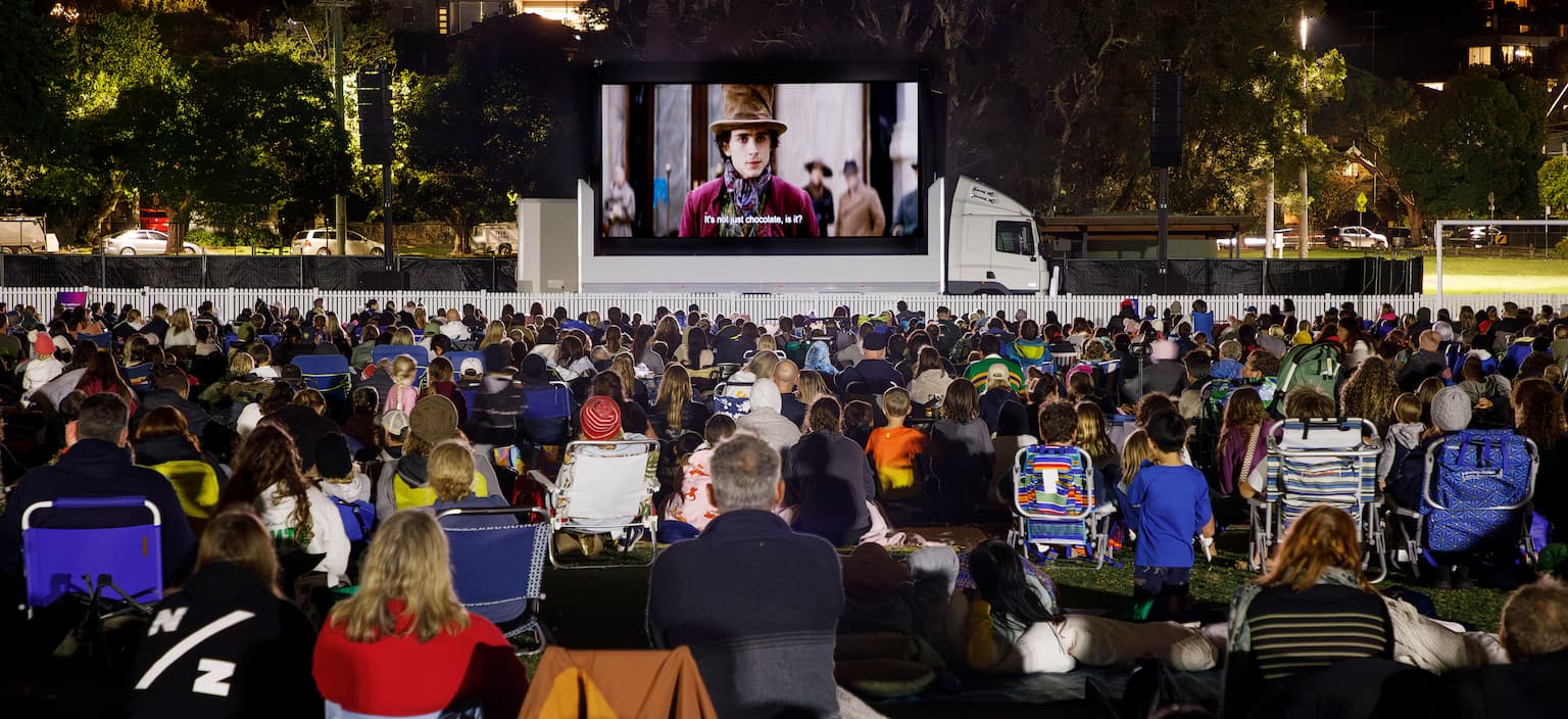 families watching an outdoor cinema