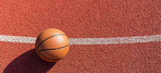 Basketball on orange basketball court