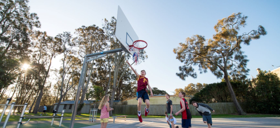 Kids shooting hoops on basketball court