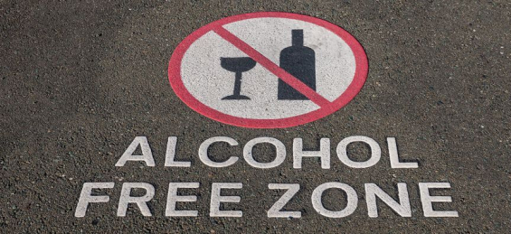 sign for alcohol free zone with line through wine glass and bottle