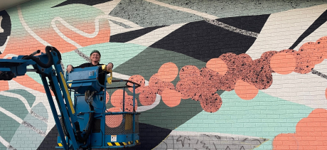 Artist Evelyn Bracewell painting her mural Bloom Wild at North Curl Curl COmmunity Centre