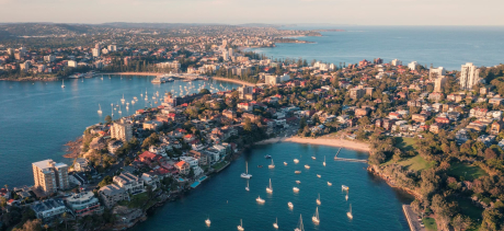 An aerial image of manly cove and manly wharf with Manly Beach in the background