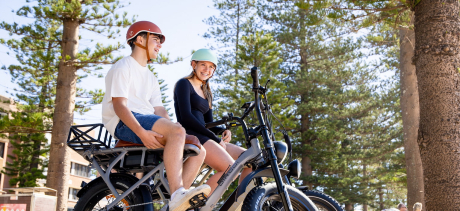 Two people sitting on e-bikes