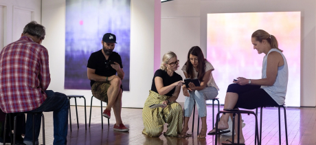 People looking at their phones in a gallery