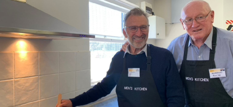 Two men in the kitchen at an event