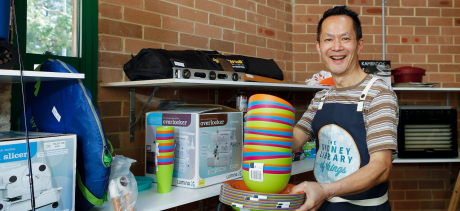 Person holding a pile of colourful plates