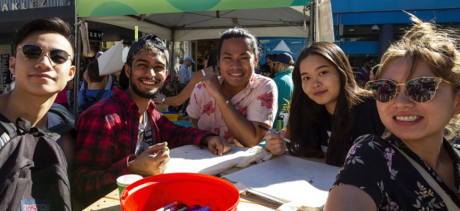 4 people around a table smiling