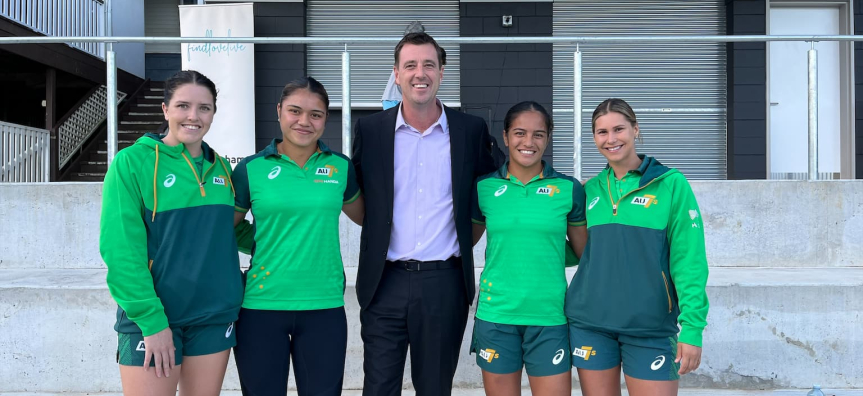 Women rugby players with Mayor Regan