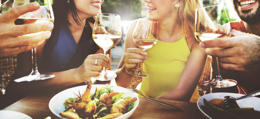 People sitting around a table eating and drinking