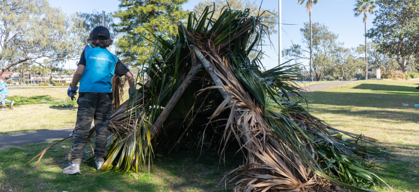 Children building a bush shelter