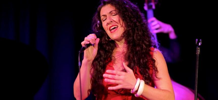 Virna Sanzone singing into a microphone