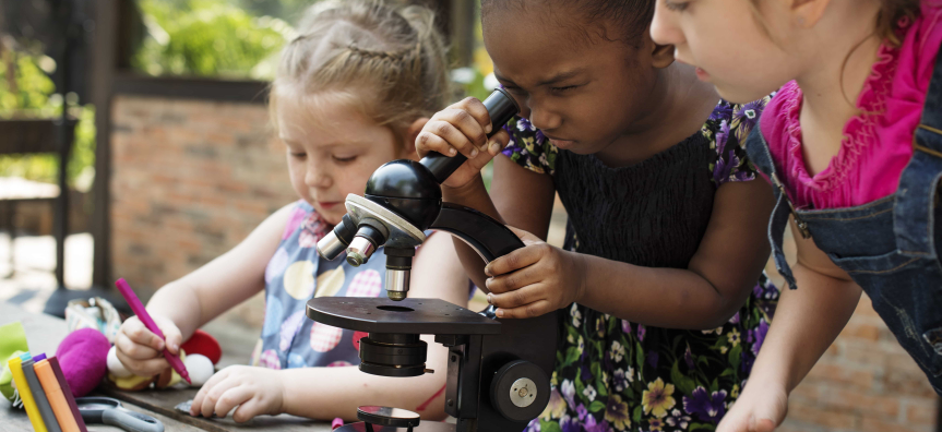 children looking through microscopes