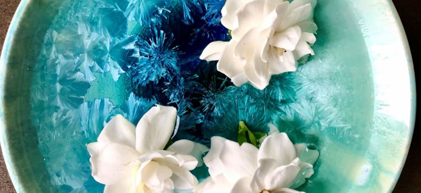 Ceramic plate with interesting blue glaze with white roses on top