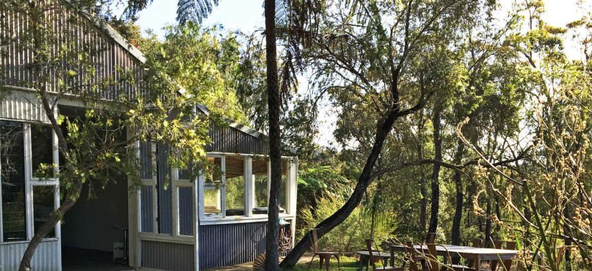 Light grey building set amongst the verdant national park.