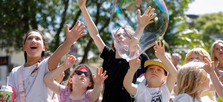 Group of children playing with a bubble