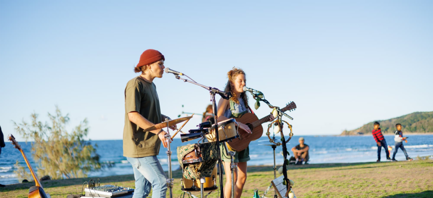 Two people busking by the beach