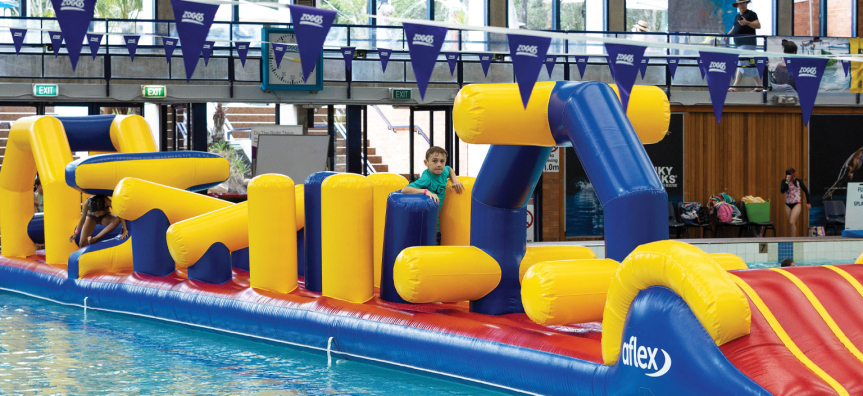 Two children playing on a pool inflatable