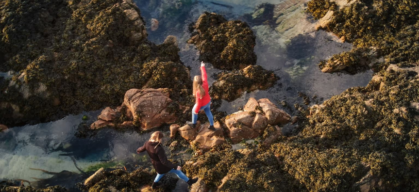 People climbing over rocks
