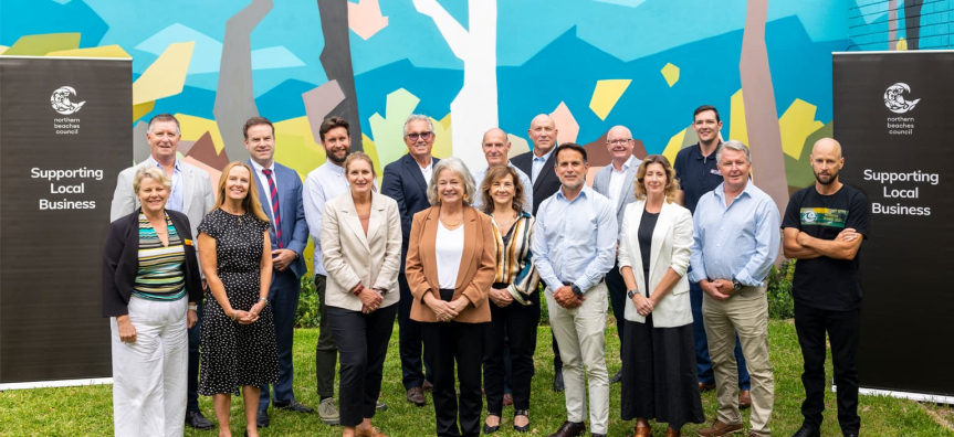 Northern Beaches Business Industry & Stakeholder Committee members standing together beside banners
