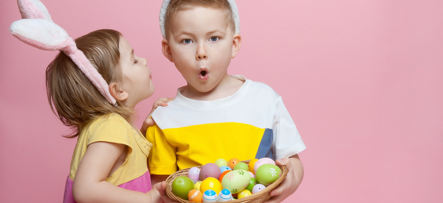 Kids holding an Easter basket of eggs