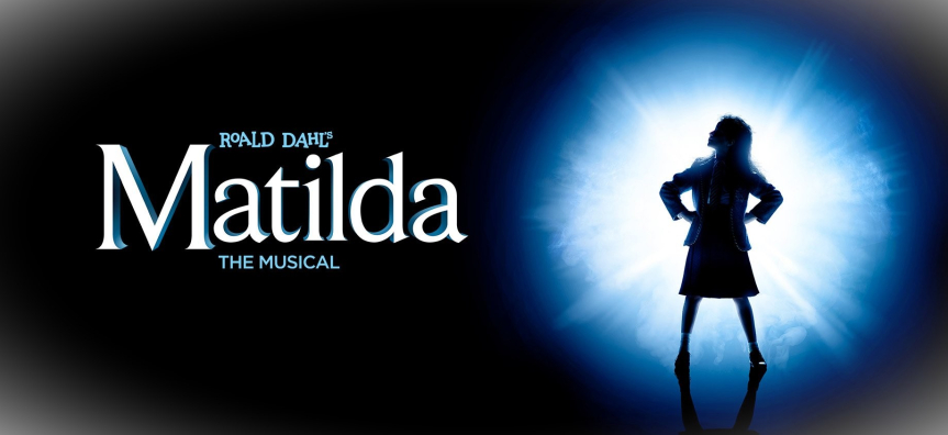 Graphic of a young girl standing proud, silhouetted by a bright light. Text reads Roald Dahl's Matilda The Musical. 