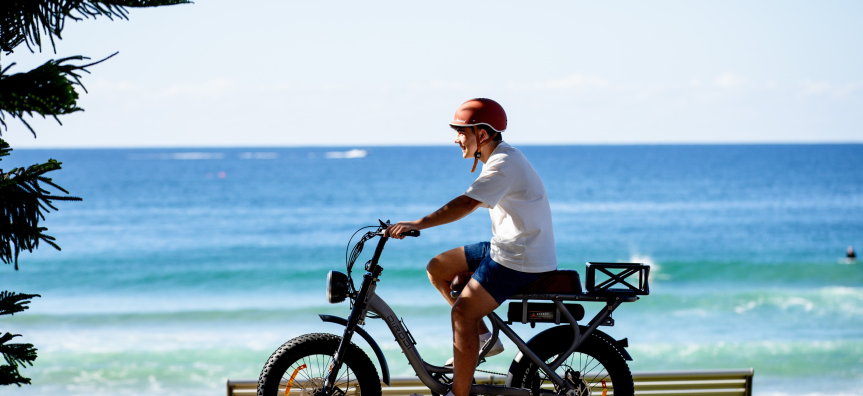 E-bike rider along Manly Beach front 