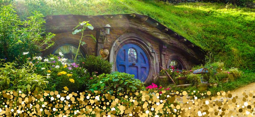 Illustration of a verdant Hobbit-like home under a grassy hill, sparkles glittering over the bottom of the image.