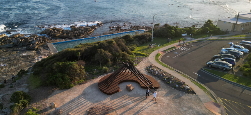 Round timber sculpture on headland