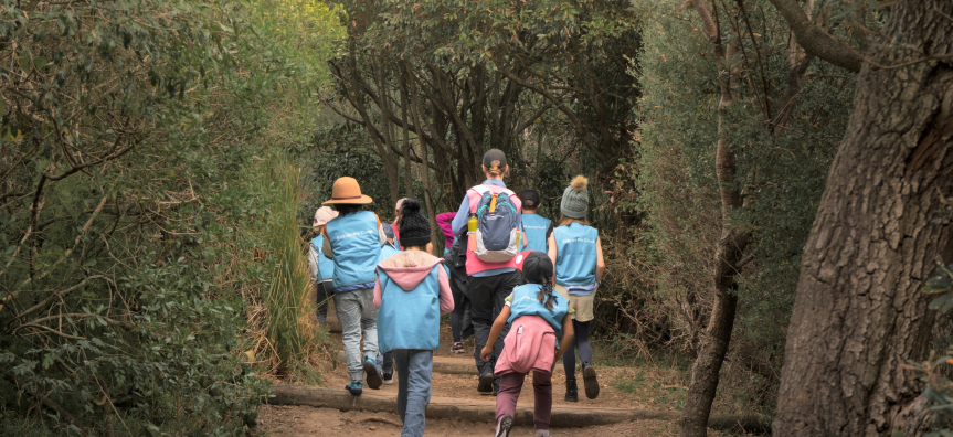children and leader on bush track