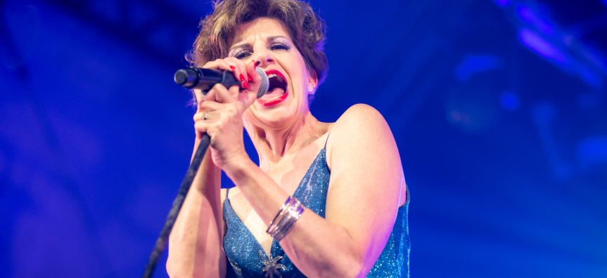 Monica Trapaga singing into microphone