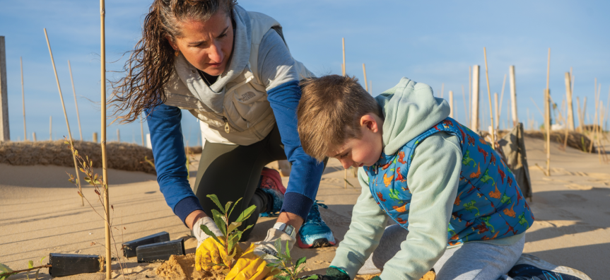 Adult and child planting a native tree