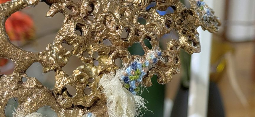 close up of a bronze cast jewellery piece, cast from a rock shelf