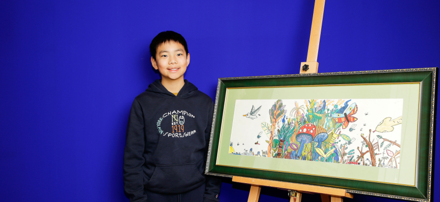 Winner to to their artwork on an easel