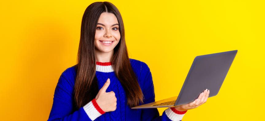 Smiling student with a laptop and thumbs up