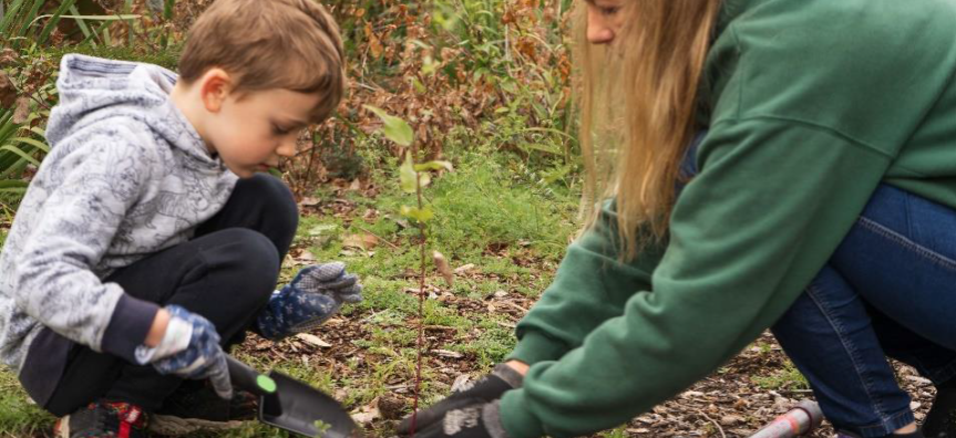 child and mum planting