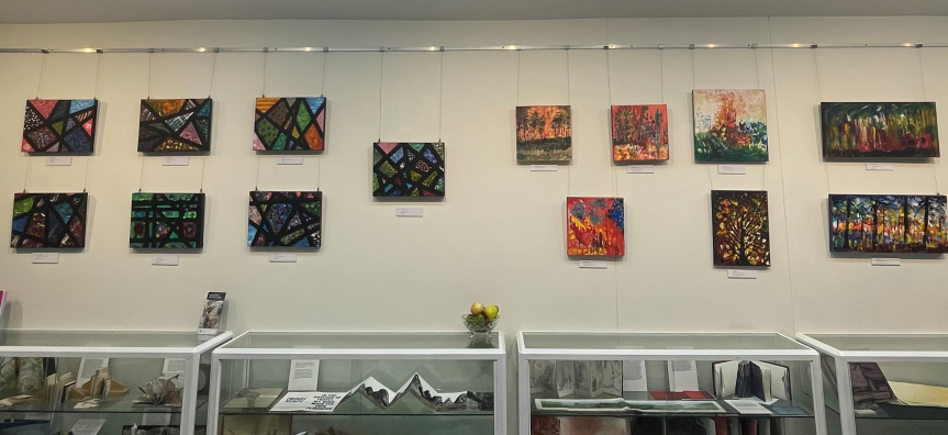 Abstract paintings by ArtAbility on exhibition wall