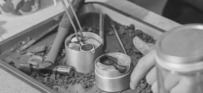 close up on an open ring mold, with tools ready to shape it. 