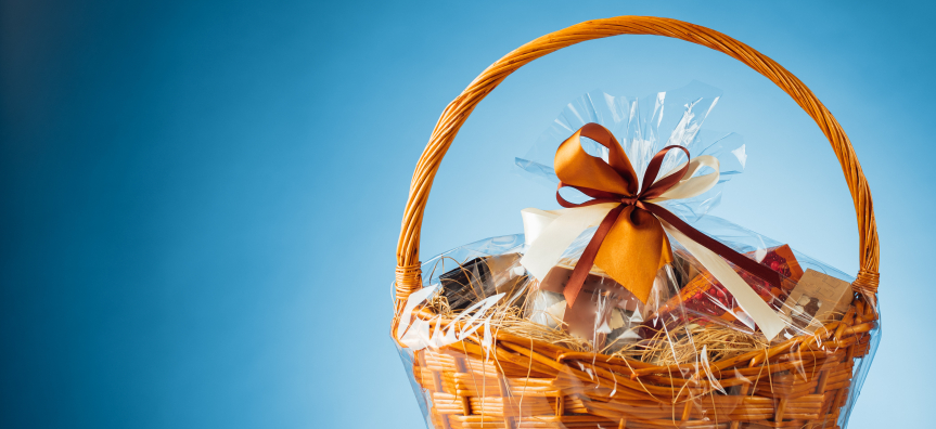 A hamper basket wrapped up with a bow.